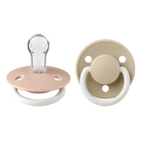 set-2-suzete-fosforescente-cu-tetina-rotunda-universala-din-silicon-de-lux-glow-0-3-ani-blush-vanilla-bibs-9744.png